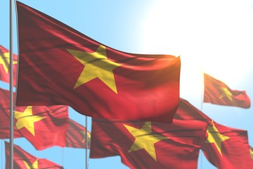 wonderful many Vietnam flags are waving against blue sky illustration with selective focus - any holiday flag 3d illustration..