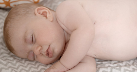 small baby girl on a bed