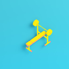 Yellow barbell with bench on bright blue background in pastel colors