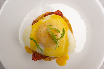 Eggs Benedict on a white dinner plate
