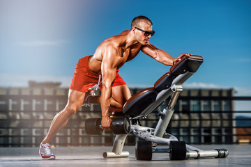 Outdoor Fitness. Muscular Men Lifting Weights at the Outdoor Gym