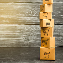 Tower of cardboard boxes with pattern of shopping carts. Purchasing power, delivery order....