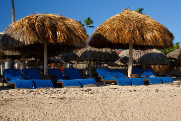 Resort sandy beach, palm umbrellas and sunbeds
