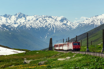Swiss alpine railway train. swiss mountain train. summer and snow