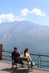 Young couple on vacation in front of lake and mountains 