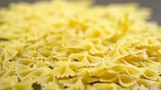 Farfalle closeup fall on a wooden table, raw pasta