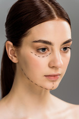 Fototapeta premium beautiful young woman with marks on face isolated on grey