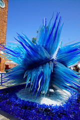 Neon blue glass sculpture promoting Murano - obrazy, fototapety, plakaty