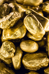 gold texture, many gold nugget, stone of value. Crude gold drawn on black background. Concept of wealth or luxury.