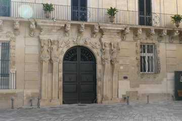 Caryatid columns support a palace entrance