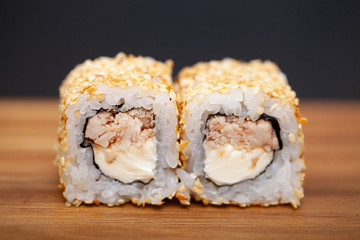 Japanese Sushi roll with salmon and cucumber on dark background
