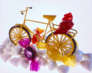 A toy bike with candy around it