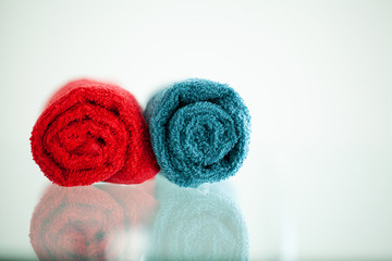 Colored towels on white table with copy space on bath room background.