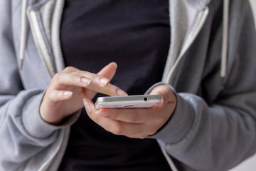 Close up woman hand holding smartphone. She using in mobile applications and multimedia programs. copy space.