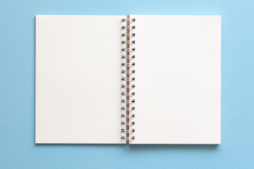 blank notebook isolated on blue background