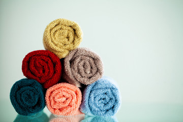 Colored towels on white table with copy space on bath room background