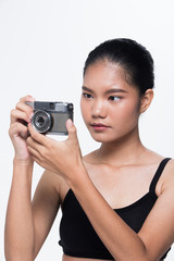 Asian Woman Photographer hold classic compact film camera with  to shoot subject, wear formal gray suit. studio lighting white background isolated copy space, reporter journalist tourist take photo