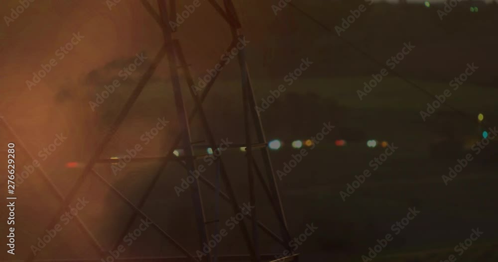 Poster transmission tower with bokeh lights and lightning in clouds