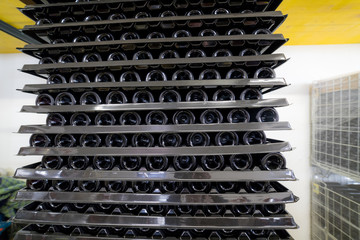 A large number of wine racks lie on top of each other in production.