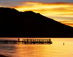 Silhouetted Couple Walks on Dock in Lake Tahoe