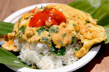 Thai street food pork omelet recipe and chili sauce with rice.