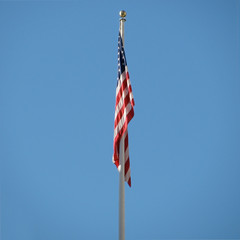 USA flag on blue sky windless