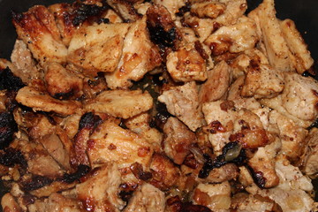 fried with onions pieces of meat close-up