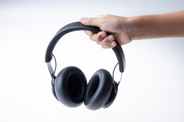 Fototapeta na wymiar headphones in hand isolated on white background