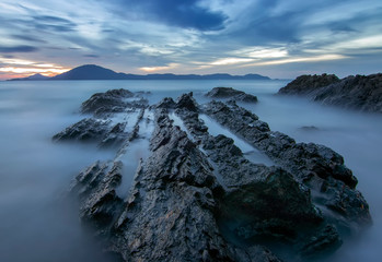 Sea dawn with waves and rocks at nha trang