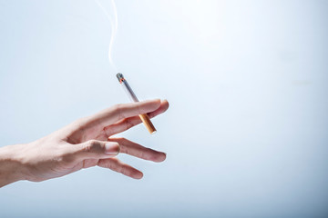 Hand holding a cigarette © Leo Lintang