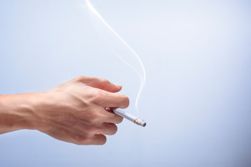 Hand holding a cigarette