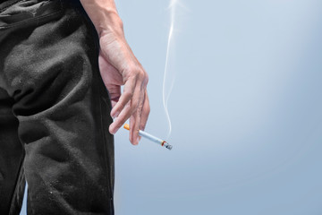 Man standing with a cigarette on his hand