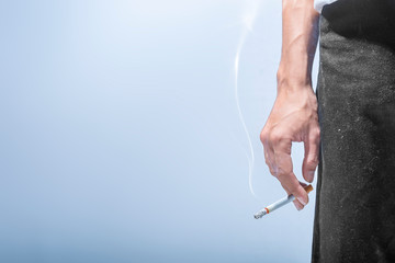 Man standing with a cigarette on his hand