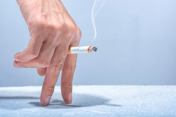Hand holding a cigarette