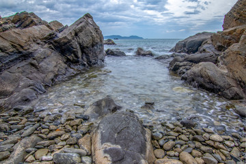 Fototapeta premium Sea dawn with waves and rocks at nha trang