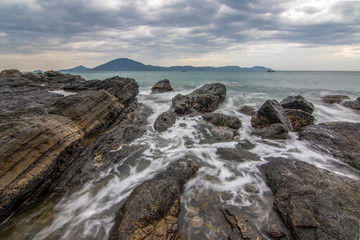 Fototapeta na wymiar Sea dawn with waves and rocks at nha trang