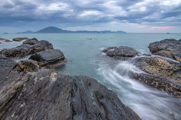 Fototapeta na wymiar Sea dawn with waves and rocks at nha trang