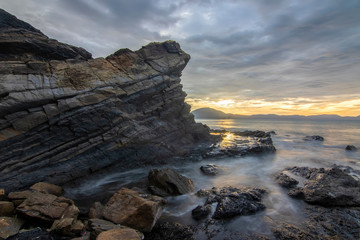 Fototapeta premium Sea dawn with waves and rocks at nha trang