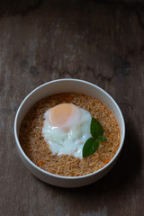 Spicy boiled instant noodles with soft-boiled egg on top. The precooked and dried noodle ready and easy to eat.