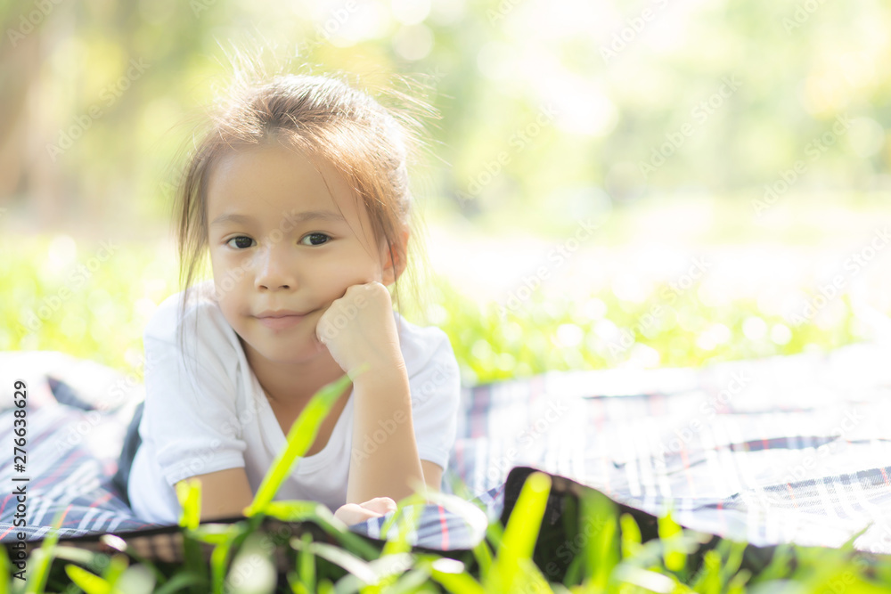 Wall mural portrait face of cute asian little girl and child happiness and fun in the park in the summer, smile