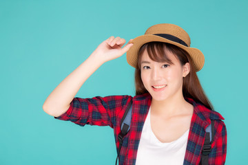 Obraz na płótnie Canvas Beautiful portrait young asian woman holding hat smile expression confident enjoy summer holiday isolated blue background, model girl fashion having backpack, travel concept.
