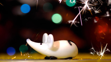 New Year and Christmas 2020. Rat and fireworks, sparklers. New year images, Mouse Figurine. Christmas Rat