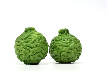 Two green Kaffir limes isolated on white background.
