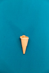 Ice cream with nuts in a waffle Cup, on a blue background