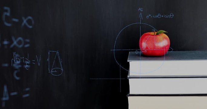 Apple on top of a pile of books and mathematical equations and graphs