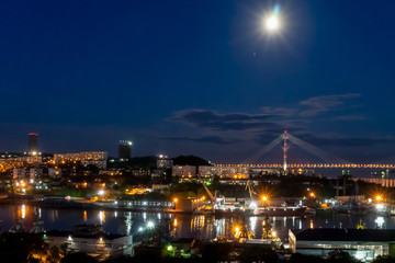 Night Vladivostok. City landscape with views of the Russian bridge.