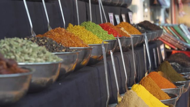 Indian spices and herbs in colorful stand market. Close-up overview of heaps.
