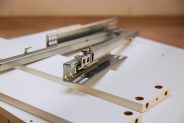 Service in the process of assembling furniture. Assembly kitchen closets and cabinets from wood and...