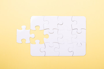 Last piece jigsaw White puzzle Concept success of business Yellow background