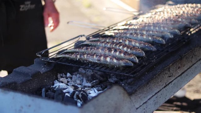 Medium shot of Steckerlfisch grilled the traditional way with charcoal.